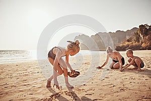 Cute little girl playing at the beach with her family