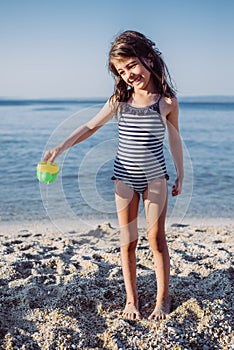 Cute little girl playing on the beach