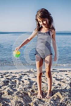 Cute little girl playing on the beach