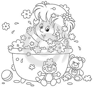 Cute little girl playing in a bubble bath