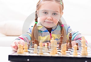 Cute little girl playing chess