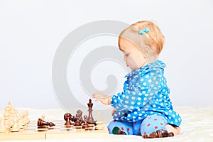 Cute little girl playing chess