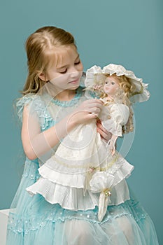 Cute little girl playing with a doll.