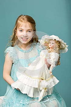 Cute little girl playing with a doll.