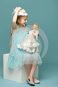 Cute little girl playing with a doll.