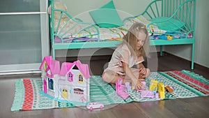 Cute Little Girl Playing with Dollhouse and Toys