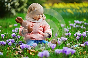 Cute little girl playing egg hunt on Easter