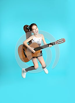 Cute little girl playing guitar