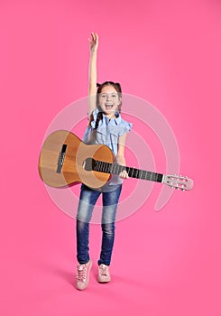 Cute little girl playing guitar