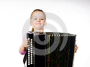 Cute little girl playing harmonica, music education concept