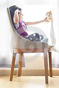 Cute little girl playing with her teddy bear