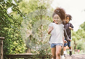 Cute little girl playing outdoor. kid and friend happy play at park.