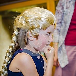 Cute little girl playing piano, dressing in retro Mozart periwig