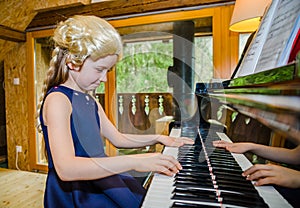 Cute little girl playing piano, dressing in retro Mozart periwig