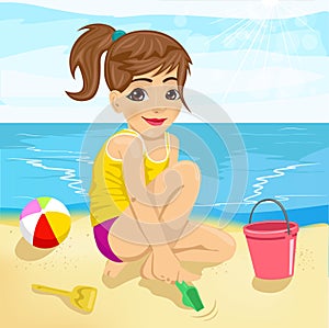 Cute little girl playing with sand on beach
