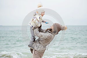 Cute little girl playing on the sandy beach. Happy child wearing