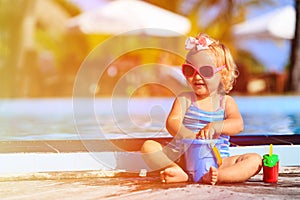 Cute little girl playing in swimming pool