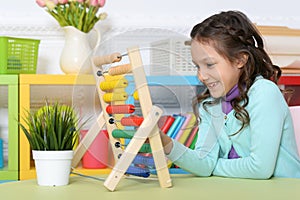 Cute little girl playing with toy at home