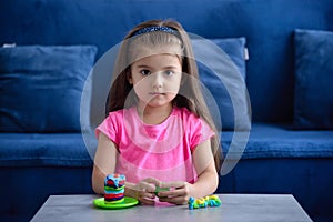 Cute little girl playing with toys at home