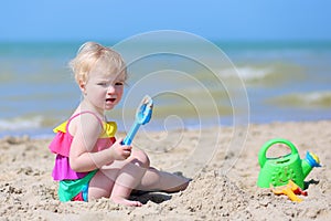 Cute little girl plays on the beach