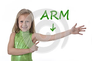 Cute little girl pointing her arm in body parts learning English words at school photo