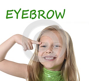 Cute little girl pointing her eyebrow in body parts learning English words at school