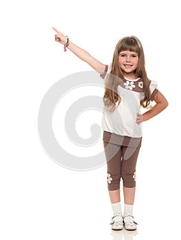 Cute little girl pointing up somewhere and smiling