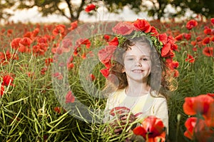 Cute little girl in the poppy field
