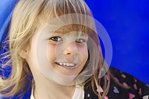 Cute little girl portrait on blue background