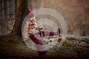 Cute little girl portrait in a spring forest at cloudy day