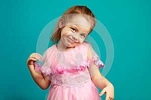 Cute little girl posing in dress ahead isolated blue