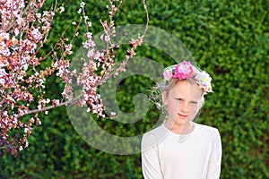 Cute little girl posing with fresh fruit in the sunny garden.