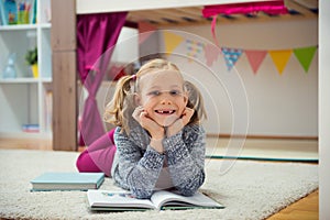 Cute little girl read book at home