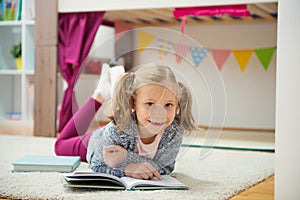 Cute little girl read book at home