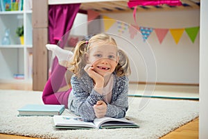 Cute little girl read book at home