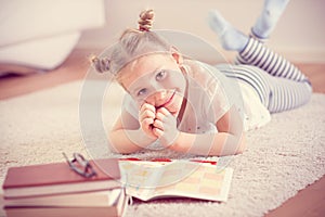 Cute little girl read book at home
