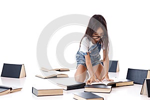 Cute little girl is reading a book.