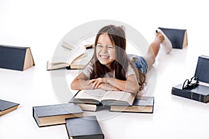 Cute little girl is reading a book.