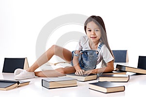 Cute little girl is reading a book.