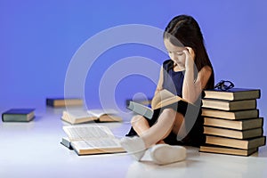 Cute little girl is reading a book.