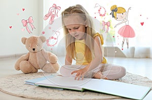 Cute little girl reading book