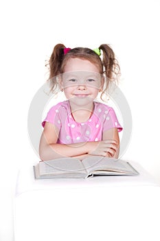 Cute little girl is reading a book