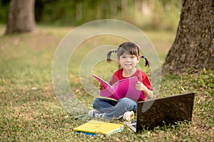 Cute Little Girl Reading Book Outside