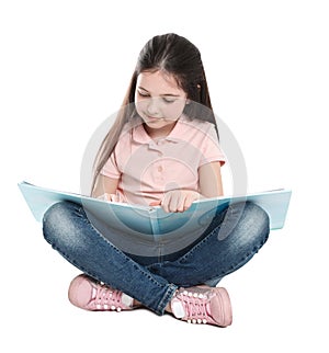 Cute little girl reading book on white