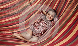 Cute little girl realxing on a hammock