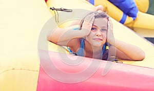 Cute little girl relaxing lying on inflatable mattress close-up portrait.