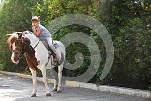 Cute little girl riding pony