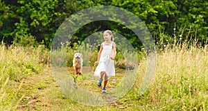 Cute little girl running with dog