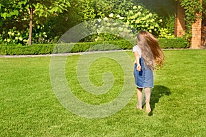 Cute little girl running in green park