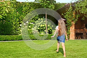 Cute little girl running in green park